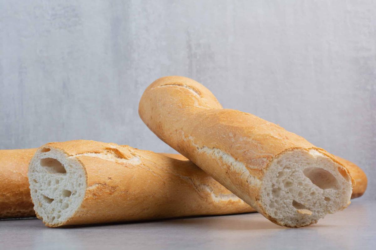 crusty baguette bread marble surface scaled