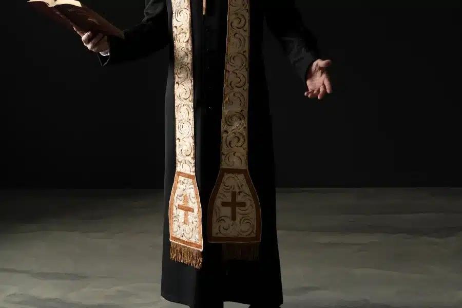 full shot christian priest reading bible