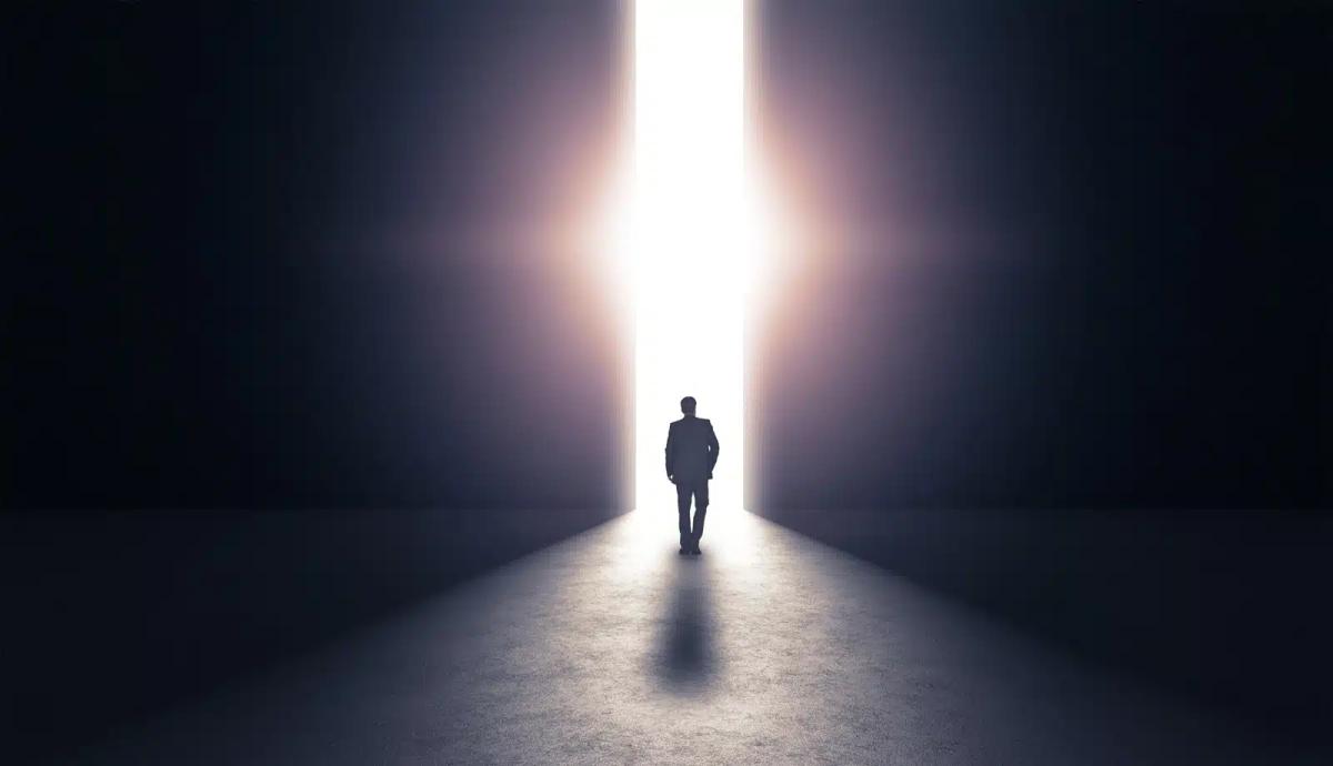 man walking towards light life after death