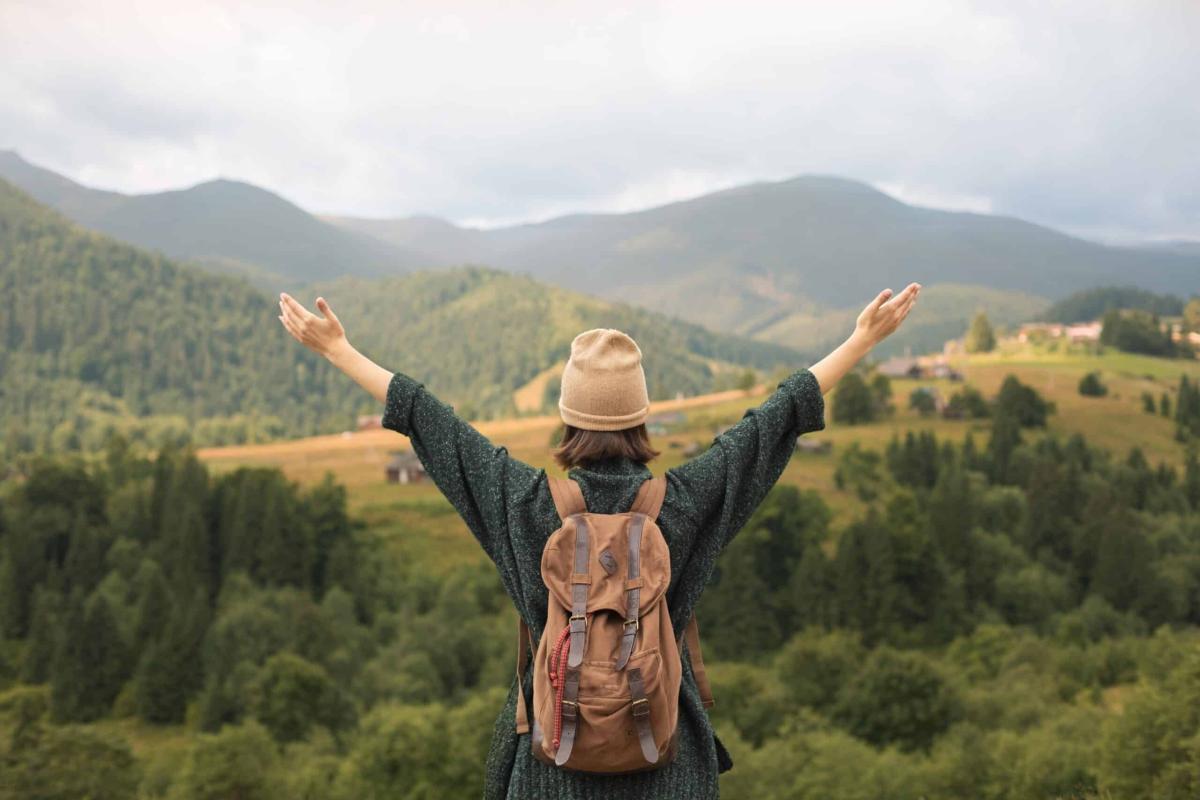 young female traveler enjoying rural surroundings scaled