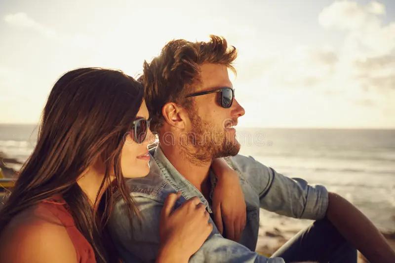 beautiful young couple enjoying view together outdoors summer day caucasian beach both wearing sunglasses 53165169