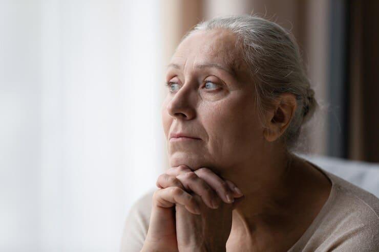 thoughtful bored older 70s woman looking window feeling depressed frustrated lonely suffering form memory loss dementia alzheimer disease mental disorder old age problems concept 650366 8734