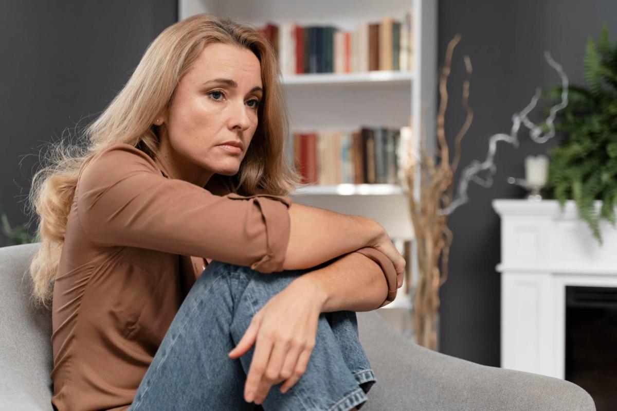 worried woman sitting couch 23 2148759101
