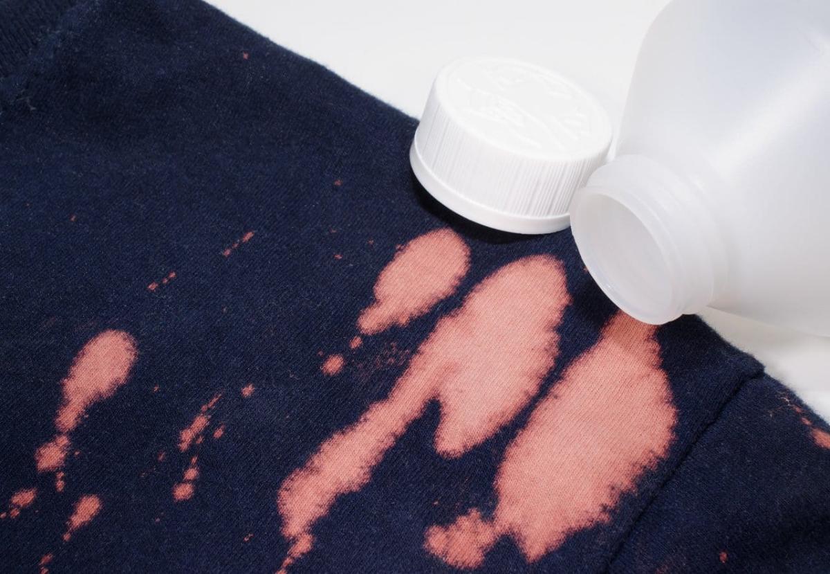 navy clothing stained with bleach